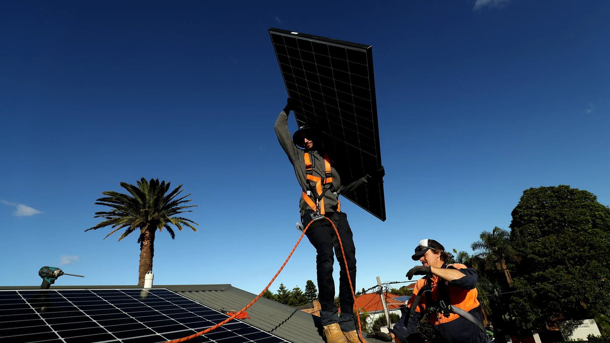 Solar panels being installed onto a Sydney rooftop. Government subsidies have helped the number installed pass 4 million. Bloomberg